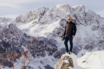 Man standing on rock against mountain