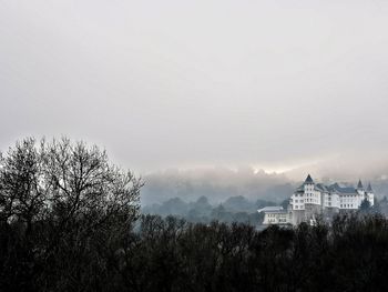 Panoramic view of buildings and trees against sky