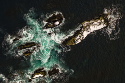 High angle view of rock formation in sea