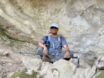Portrait of ravi siting on rock