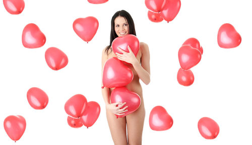Woman standing with pink balloons against white background