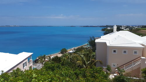 High angle view of built structures against calm blue sea