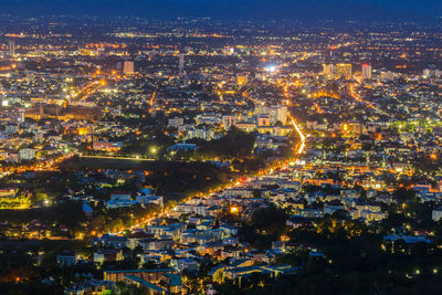 High angle view of illuminated cityscape against sky at night