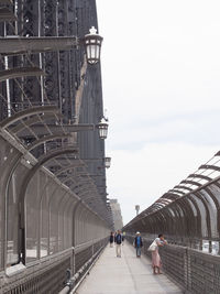 People walking on footbridge