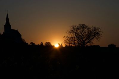 Silhouette trees against sky during sunset