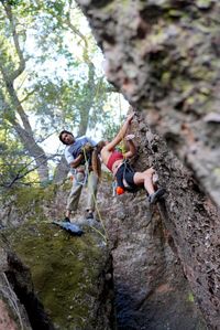 Rear view of man climbing on rock