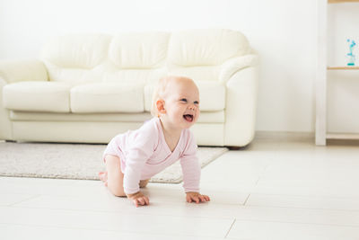 Cute baby boy on sofa at home