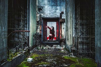 Full length of woman in red dress at nuclear power station