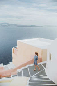 Man standing on sea against sky