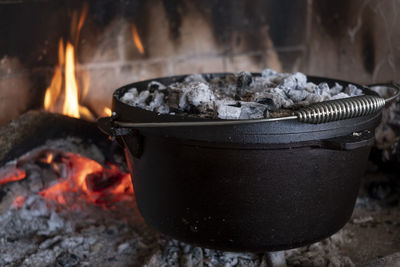 Cooking in pot, close-up of fire