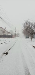 Snow covered road against sky