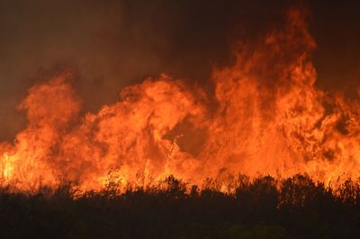 Panoramic view of bonfire against sky at night