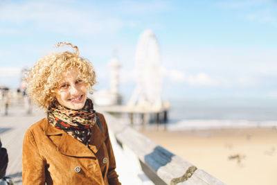 Portrait of smiling woman against sky during winter