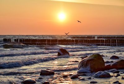 Scenic view of sea against sky during sunset