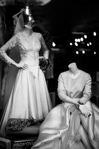Mannequins wearing dresses seen from window display