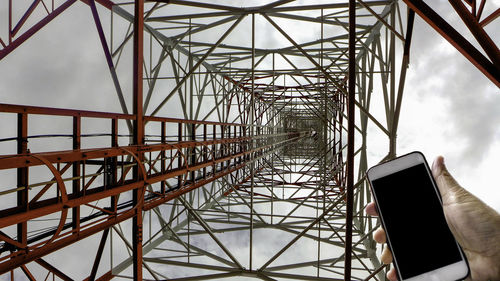 Low angle view of electricity pylon against sky