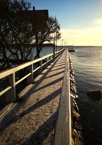 Pier on river at sunset