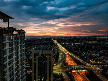High angle view of illuminated buildings against sky during sunset