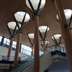 Low angle view of illuminated lamp hanging on ceiling of building