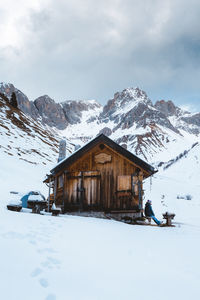 Built structure on snowcapped mountain against sky