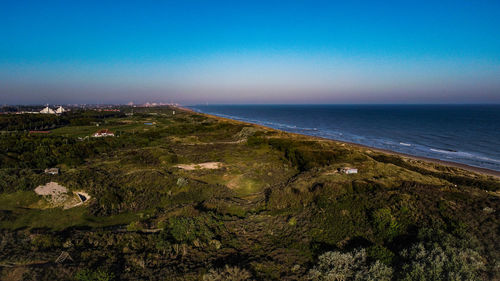 Scenic view of sea against clear blue sky