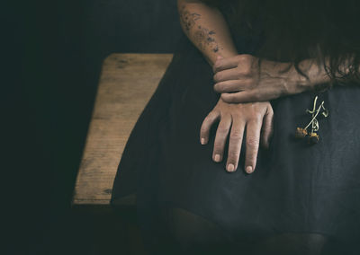 Woman in black dress with dried flowers in her hand viii