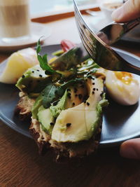 Close-up of hand holding food on table