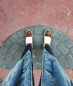 Low section of man standing on footpath