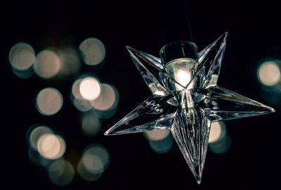 Close-up of illuminated lamp against black background