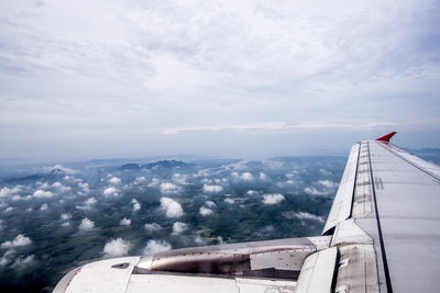 Aerial view of airplane wing against sky