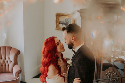 Young couple kissing at home