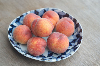 High angle view of apples in plate on table