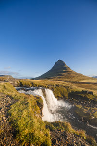 Scenic view of mountains against clear blue sky