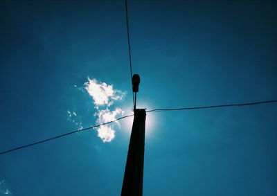 Low angle view of street light against blue sky