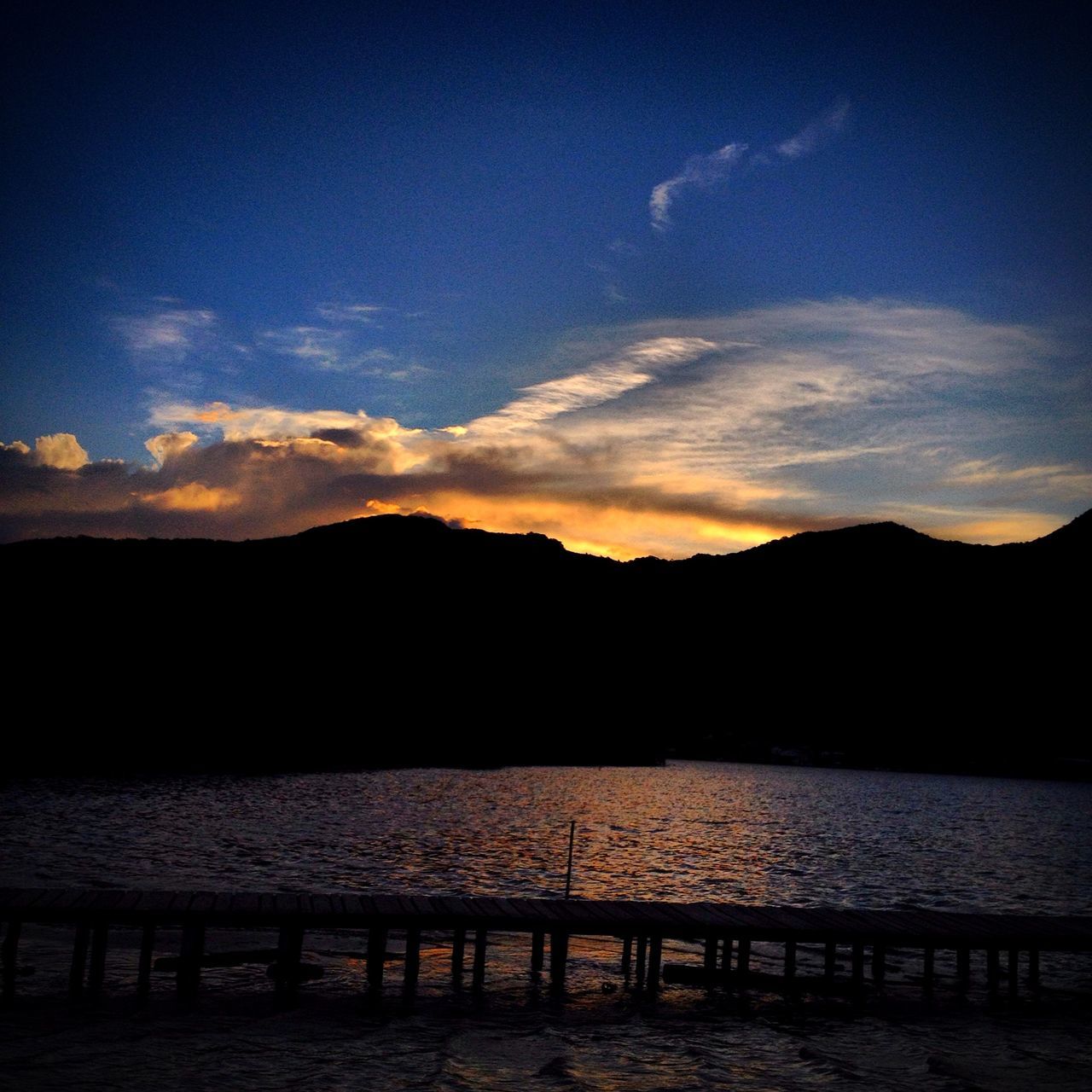 water, silhouette, sunset, tranquil scene, scenics, tranquility, sky, beauty in nature, mountain, lake, idyllic, nature, sea, dusk, mountain range, calm, reflection, cloud, cloud - sky, river