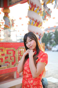 Portrait of a beautiful young woman standing outdoors