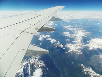 Cropped image of airplane flying over landscape