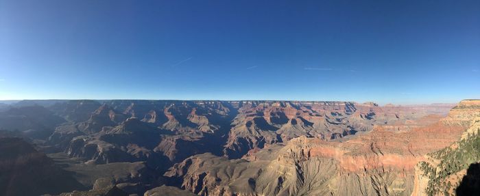 Scenic view of mountains against clear blue sky