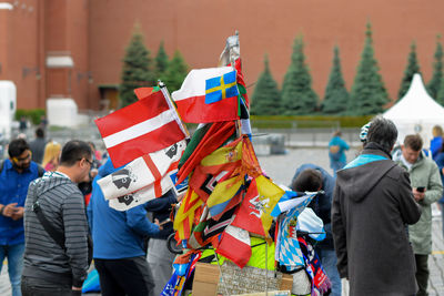 Rear view of people with umbrellas flags