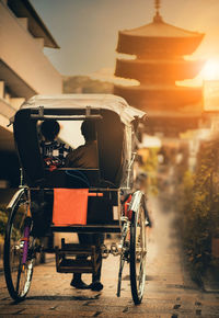 Bicycles on street against buildings at night