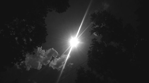 Low angle view of silhouette trees against sky