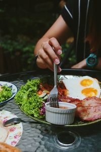 Person holding ice cream in plate