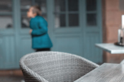 Rear view of woman sitting on chair