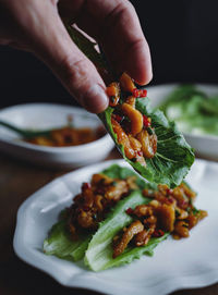 Close-up of hand holding salad