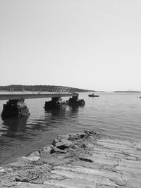 Boats in sea against clear sky