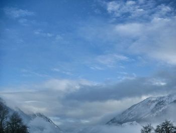 Low angle view of snow covered mountain against sky