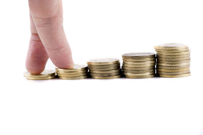 Close-up of coin stack against white background