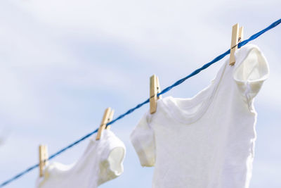 Low angle view of clothes drying against sky