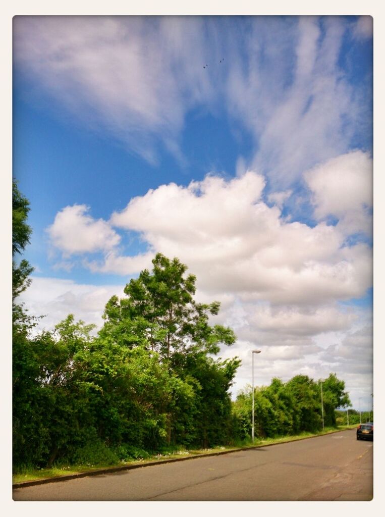 VIEW OF ROAD AGAINST CLOUDY SKY