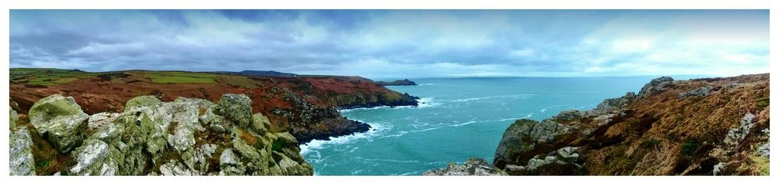 Scenic view of sea against cloudy sky